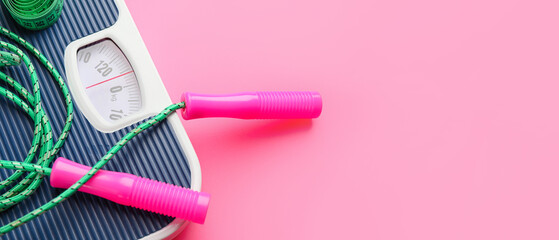 Weight scales with jumping rope on color background, closeup. Slimming concept
