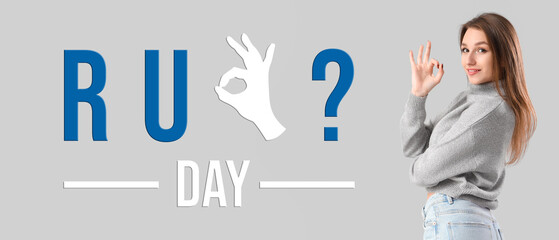 Young woman showing OK on light background © Pixel-Shot