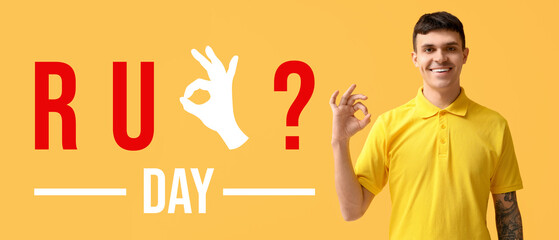 Young deaf mute man using sign language on yellow background