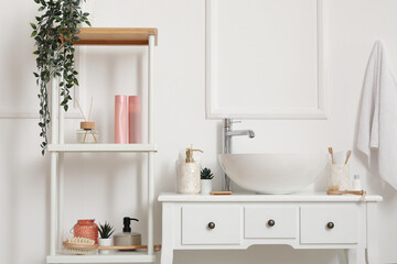 Sink bowl with bath accessories on table in bathroom
