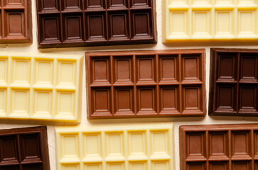 Background of dark, milk and white chocolate bars. Top view. 
