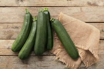 Many fresh zucchini on brown wooden background