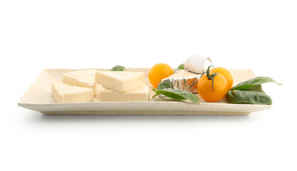 Plate with triangles of tasty processed cheese, cherry tomatoes and basil leaves on white background