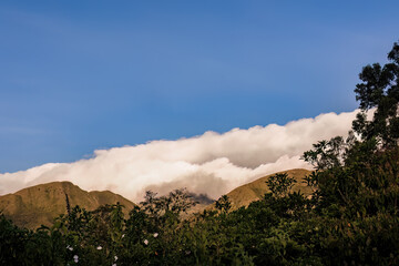A dense cumulus cloud covers the top of the Iguaque mountain at sunset, producing a thick mist, in the eastern Andes of central Colombia.