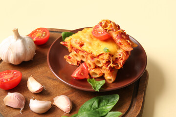 Plate of pasta with tomato sauce and cheese on beige background