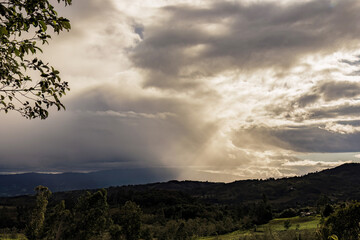 View of beams of sunlight projected over the eastern Andean mountains and farmlands of central...