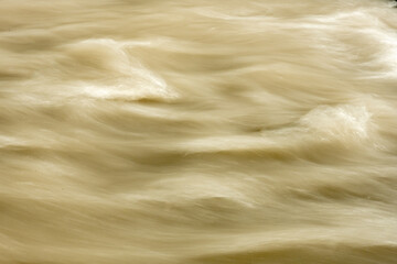 Small Waves Of Muddy Snow Melt Fill The Carbon River In Mount Rainier