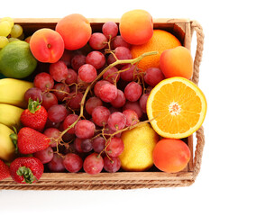 Wooden box with different fresh fruits on white background