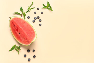 Piece of fresh watermelon and blueberries on orange background