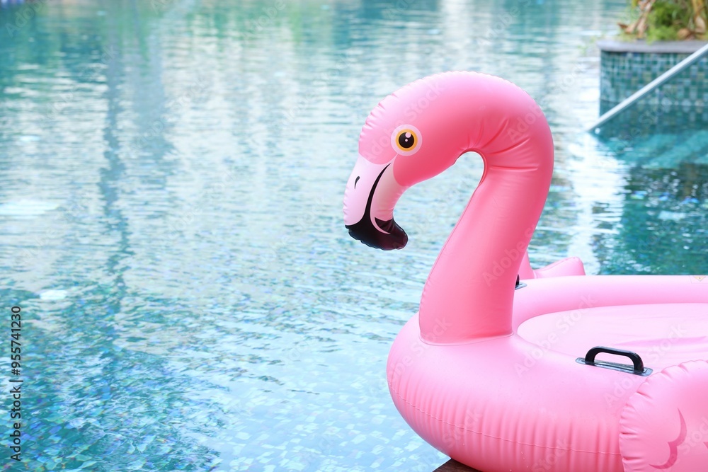 Wall mural inflatable float in shape of flamingo near outdoor swimming pool