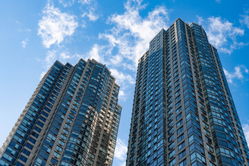 Naklejka premium City architecture. Architecture of modern glass building. Perspective city skyscraper. Modern skyscraper building. Glass building in metropolis. Skyscraper perspective view. Low angle view