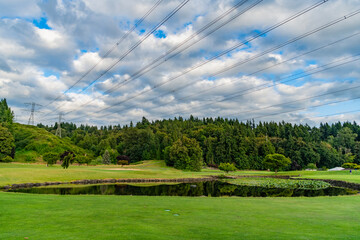 Green nature energy. Landscape of electric voltage station. High voltage. Electricity pylon. Nature summer environment. Electricity tower. Electricity power lines in nature landscape. Electrical grid