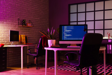 Interior of dark office with programmer's workplaces