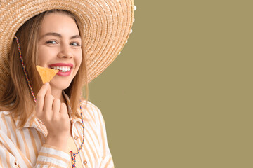 Young woman in sombrero hat with nacho on green background, closeup. Mexico's Day of the Dead (El...