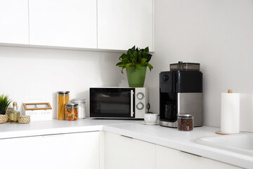 Modern coffee machine on white counter in kitchen