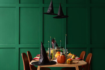 Festive table with pumpkins and burning candles served for Halloween party at home