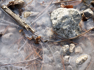 Beautiful still life with frozen  Autumn leaves and stones on creek bed in Seoraksan National park, Korea 