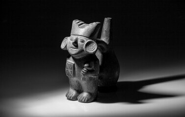 Ancient Peruvian ceramic figurine with intricate carvings