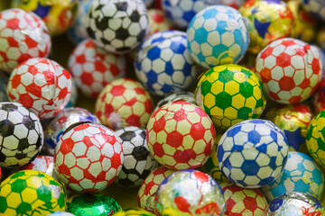 Colorful chocolate soccer ball candies in various patterns.