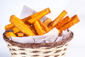Basket of crispy golden brown sweet potato fries.