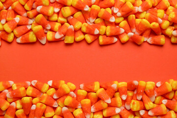 Composition with tasty Halloween candy corns on color background