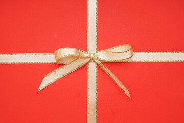 Ribbons with bow on red background