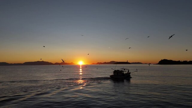 fishing boat sunrise on the sea in Paraty