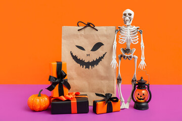 Composition with shopping bag, decorations and gifts for Halloween on color background