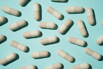 Group of pills capsules, the nutritional supplements, vitamins medicine tablets on blue background