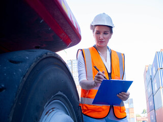 Female woman white hardhat safety uniform report information document tablet checklist forklift tire work job occupation career manager supervisor person people technology import export logistic  © StreetOnCamara