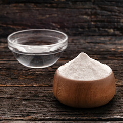 Vinegar and baking soda mix in a glass bowl.