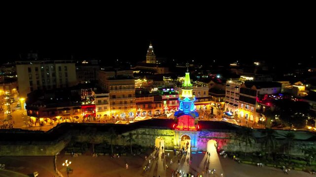 Aerial Cinematic view of the city of Cartagena at night in colonial  Clock tower 