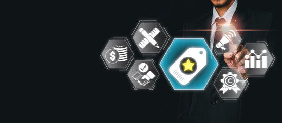 Businessman using virtual screen to interact with digital brand concept icons, representing marketing, strategy, and business growth.