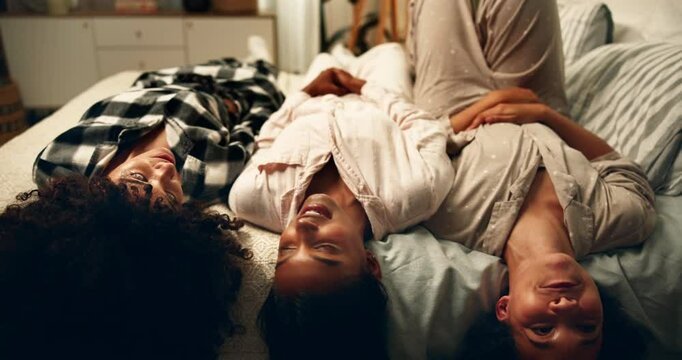 Women, friends and laying in bed at night for fun, support and bonding with conversation. People, relationship and happy or smile on sleepover for relax, care and break for girls time or gossip