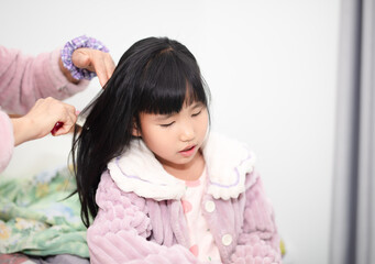 girl is combing her hair