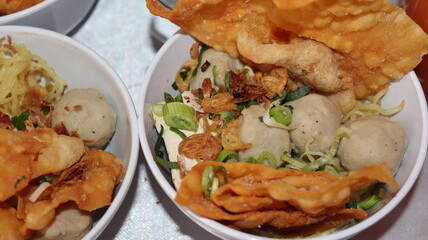 Bakso Malang, meatball soup from Malang, East Java served with noodles, tofu, and fried pangsit or...