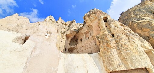 Goreme valley with ancient chapels houses carved into hillside, Cappadocia, Turkey
