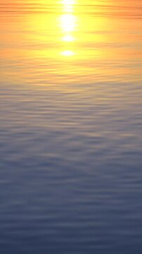 Sun and water. Vertical video of a majestic sunset on a water surface.