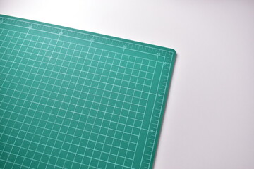 green cutting mat board on white background with line and scale measure guide pattern for object...