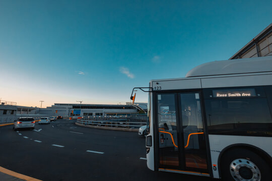 Traffic on road at Sydney Domestic Airport with plane coming in to land