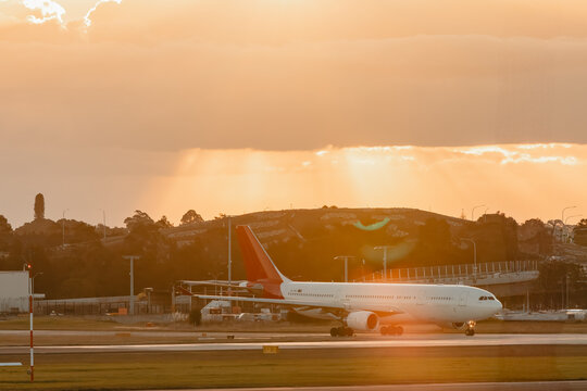 Airplane on the tarmac at Sydney Domestic Airport in golden afternoon light