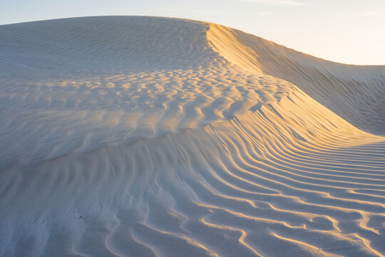 Detailed view of ripples and patterns on the side of sand dunes