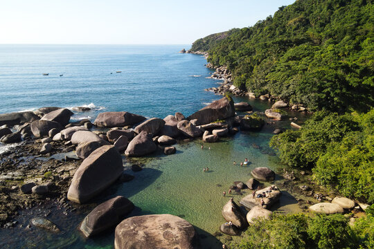 Natural pool among the rocks. Calm and crystal clear turquoise sea. Paradise landscape. People having fun in the summer