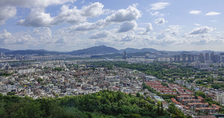 Yongsan-gu, Seoul, South Korea - August 18, 2021: High angle and panoramic view of townhouses and highrise apartments seen from Namsan Mountain in summer