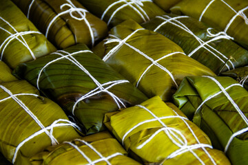 Close-up of background of hallacas, venezuelan traditional christmas food. Banana leaf and corn dough stuffed with a stew of beef. Latin american dish.