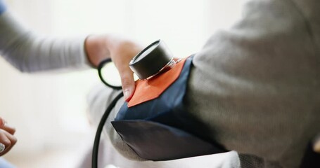 Blood pressure, consulting and closeup of nurse with arm of patient for medical care, wellness and service. Healthcare, hospital and doctor with heart rate machine on patient for cardiology support