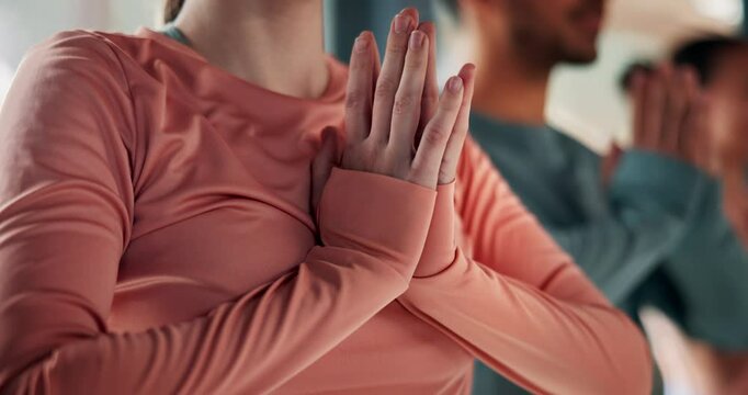 Yoga, namaste and hands of people in class for fitness, natural exercise and morning balance together. Workout, pilates and group relax for muscle warm up, body wellness and self care in studio gym