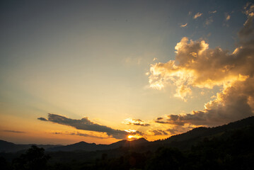 Scenic view dramatic beautiful sunset sky. Natural Sunset Sunrise on meadow silhouette shadow dark land. Vibrant dramatic sky on sunset, dawn, sunrise in Countryside. Landscape Colorful Sky At Sunset