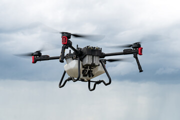 Modern technologies in agriculture. an industrial drone in the sky, on a blue background of clouds....