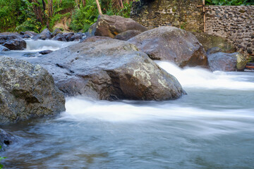 beautiful mountain water flow passing through river stream